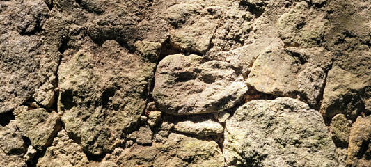 old stone wall with shadows and sunlight, rustic background
