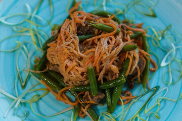 Meat stew with carrots and green beans asparagus on a plate
