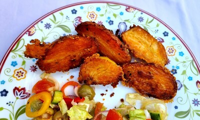 Homemade salad with baked crispy potatoes