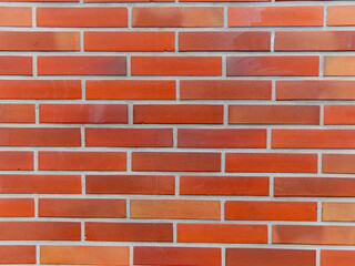 pink, orange brick wall of the exterior facade of the house