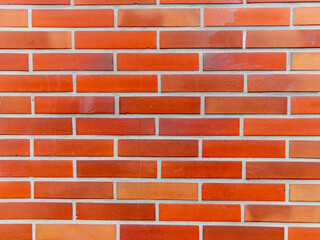 pink, orange brick wall of the exterior facade of the house