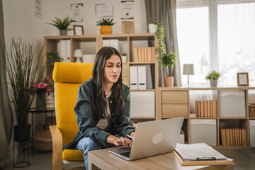 Adult young caucasian woman work from home and use laptop