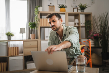 adult exhausted worried man use laptop for work or explore at home