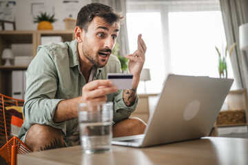 adult angry man have online shopping on laptop with credit card