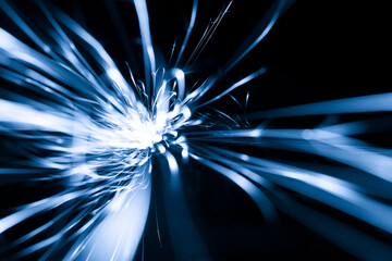 blue sparks from the grinder glowing in the dark