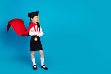 Full body portrait of little schoolkid uniform mortarboard look empty space isolated on blue color background