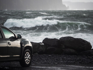 Car parked close to the ocean with view on amazing nature scene with powerful waves. Doolin area,...