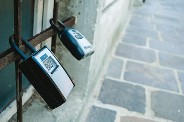 Security boxes for storing keys to tourist apartments, in the form of a padlock on the street.