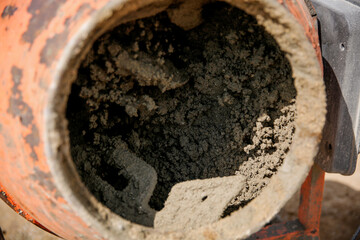 Concrete in an orange mixer on construction site
