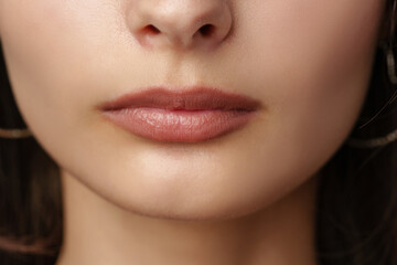 Close Up Of A Woman's Mouth With Nude Lipstick