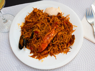 National dish of Mediterranean cuisine is pasta with seafood, cooked with addition of shrimp,...