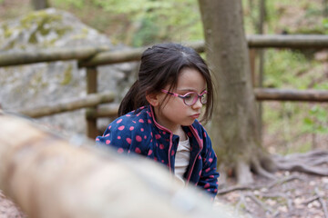 Little girl with glasses in the mountains. Little traveler on a hike. Concept of children's...