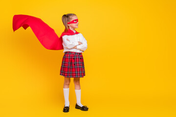 Full body portrait of little schoolkid superhero costume uniform crossed arms look empty space isolated on yellow color background