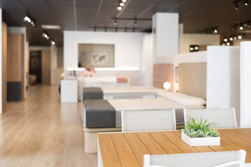 Interior of furniture salon shopping room with tables and sofas .