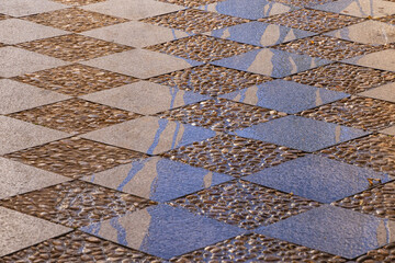 Cut stone tiles and cobbles pave a plaza in Granada.