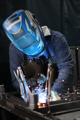 people working on welding in the factory