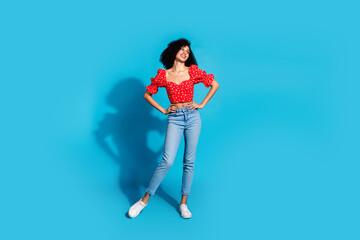 Full size photo of pretty young woman look empty space wear top isolated on blue color background