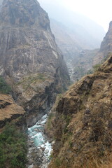 Powerful mountain river flows through a deep gorge in the majestic himalayas, carving through rocks to create a breathtaking scene of raw beauty and power