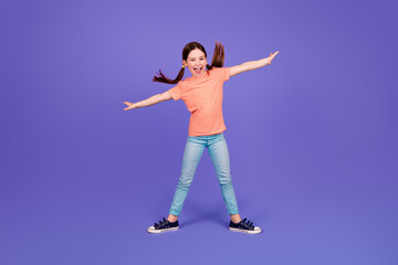 Full size photo of little girl spread hands fly surfing keep balance dance wear trendy red outfit isolated on purple color background