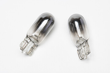 Pair of burnt or blown T10 halogen bulb.Isolated on white background. Selective focus