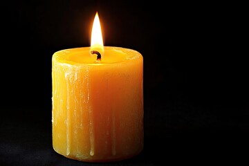 A yellow candle burning brightly. This image is perfect for projects related to hope, remembrance, or spiritual themes.