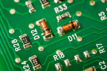 Small glass diodes on a printed circuit board.
