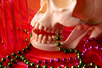 Close up of white skull and colorful festival stuff for day of the dead, orange color background