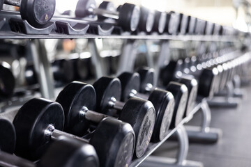 Rows of dumbbells for weight training in gym