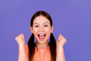 Photo portrait of pretty little girl winning raise fists excited wear trendy red outfit isolated on...