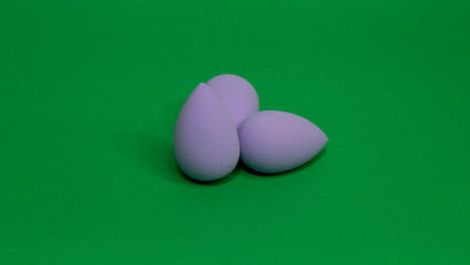 makeup sponge on green background