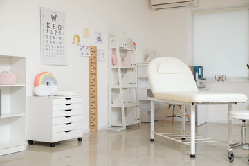 Interior of pediatrician's office with eye test chart and stadiometer
