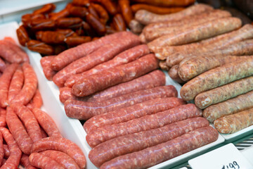 Closeup of appetizing chorizo, morcilla, butifarra and chistorra sausages offered for sale in...