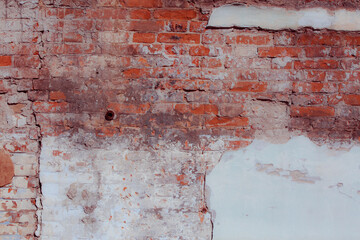 White shabby grungy brick wall. Free space for an inscription. Can be used as a background or poster. Fragment of a red brick wall with bumps and textured plaster.	
