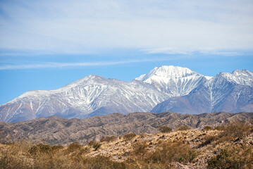 A sunny morning in a mountain Andean landscape in Mendoza, Argentina. Snowy peaks stand out on the...