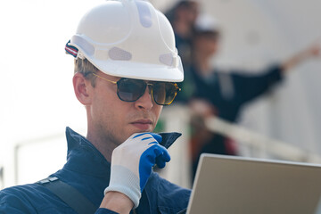 engineers working in fieldwork outdoor. Workers walking and inspect construction and machine around project site. Wind turbine electrical of clean resource enerdy and environment sustainable.