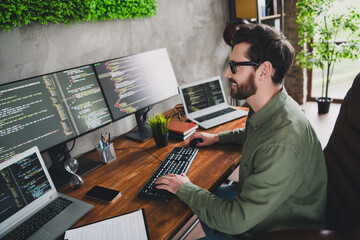 Photo of professional it specialist young man write keyboard computer desktop loft interior office...