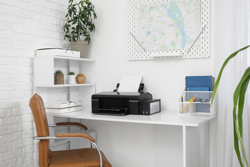 Modern printer on workplace in stylish office
