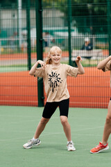 Obraz premium An energetic young girl is seen in mid-motion during a fun outdoor sports session, showcasing her enthusiasm and love for physical activity.