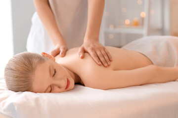 Young woman having spine massage in spa salon