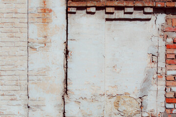 White old grungy brick wall. Fragment of a wall with bumps and peeling paint. Restoration of semi-antique brick walls. A basic neutral background for a design project.