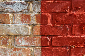 Old urban weathered brick wall half painted with red paint, two different parts . Bicolor abstract background, close up