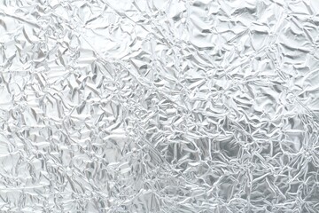 Shiny silver tinfoil surface as background, top view