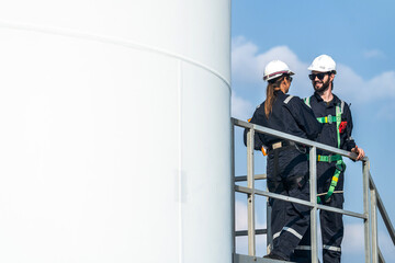 engineers working in fieldwork outdoor. Workers walking and inspect construction and machine around project site. Wind turbine electrical of clean resource enerdy and environment sustainable.