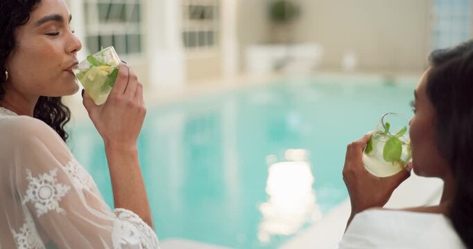 Women, cheers and drinks at hotel pool for holiday, happiness and relax with glass, alcohol and smile. Friends, celebrate and gin cocktail together at luxury resort for vacation, wellness and travel