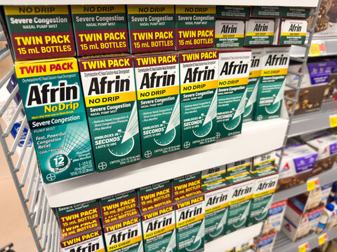 Afrin nose sprays twin and single packs on display inside a department store.