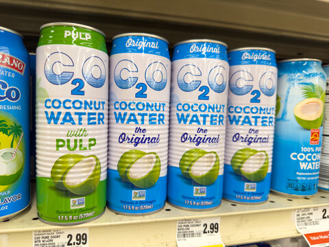 Cans of C2O coconut water in original and pulp varieties. 