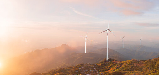 Mountain valley with wind turbine at colorful sunrise. Ecological energy concept