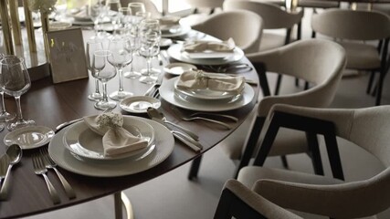 Elegant wedding table setting with pristine dishware and glasses.