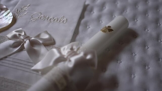 Elegant baptism set with personalized towel, seashell, candle, and delicate ribbons