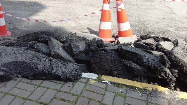 Big pot hole filled with water at street
